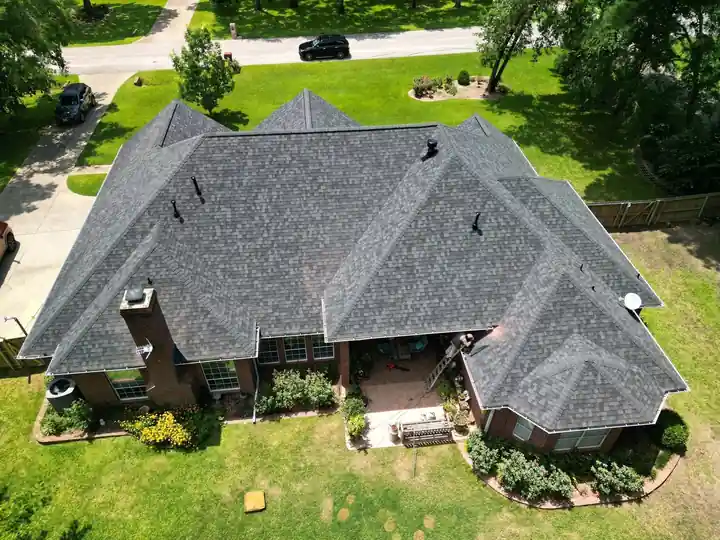 Brick home with a new roof seen from the corner