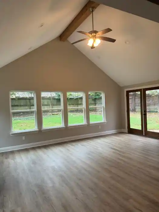 A finished vaulted room after restoration, new floor and a ceiling fan